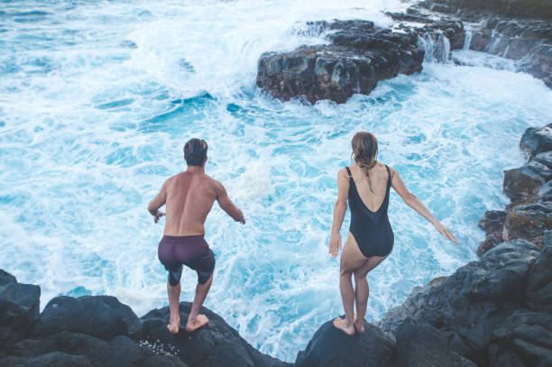 istock A millennial-age couple getting ready to jump into the ocean 1053658716
