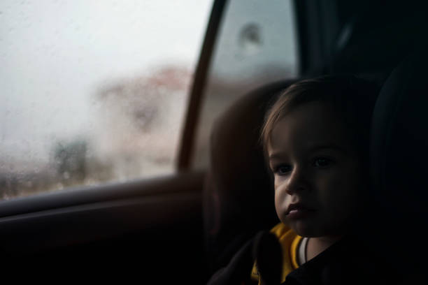 istock Baby boy into him car seat in rainy day 1053661544