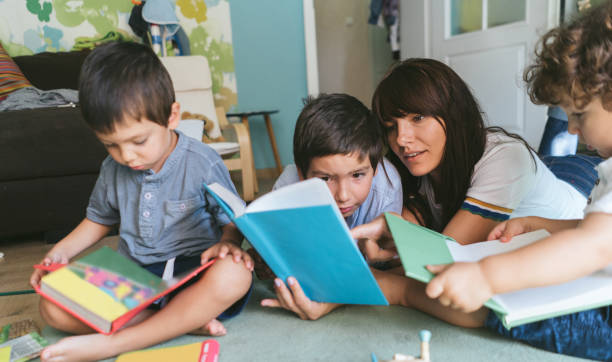istock Mother and sons reading a book together 1053664956