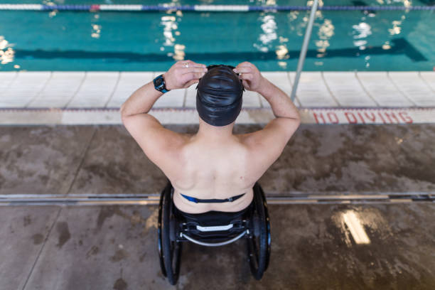 Adaptive athlete prepares to swim in a pool