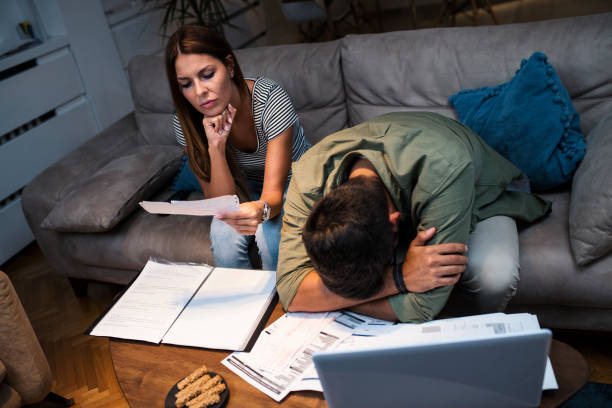 istock Worried young couple with financial bills 1053690062