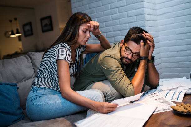 istock Worried young couple with financial bills 1053692676