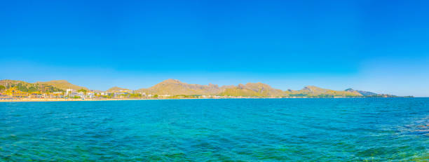 Holiday resorts stretched alongside Alcudia beach on Mallorca, Spain