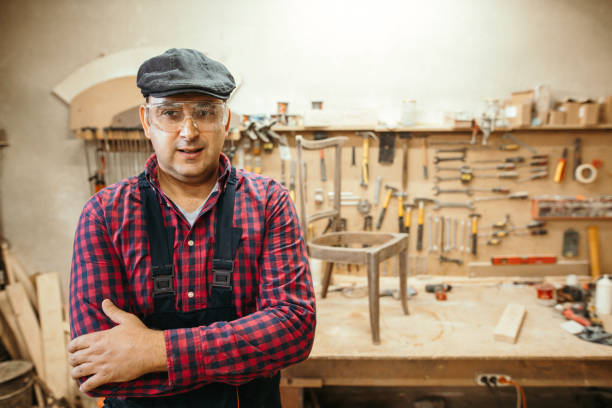 istock Young carpenter restoring old furniture 1053695662