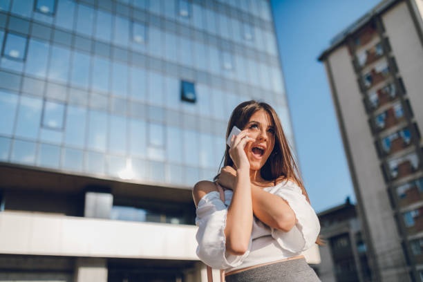 istock Businesswoman using phone downtown 1053696048