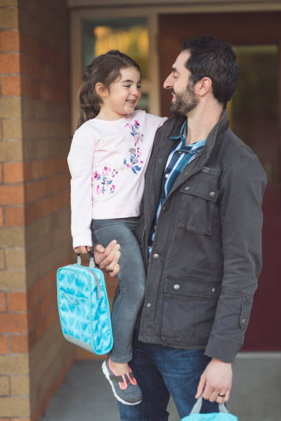istock Dad drops little girl off at school 1053696088
