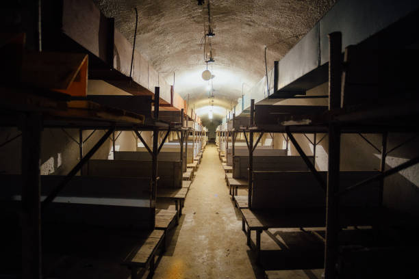 Wooden double-decker beds inside old abandoned soviet bomb shelter.