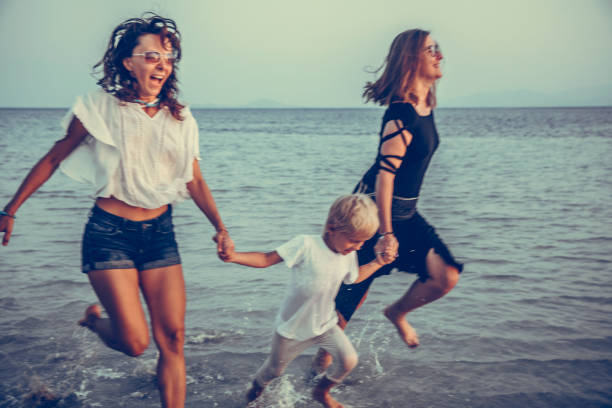 family is running on the tropical beach