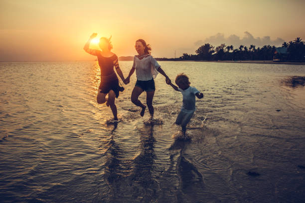 istock family is running on the beach 1053706236