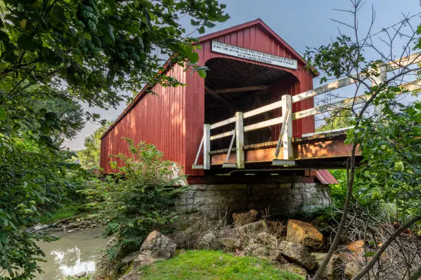An old red wooden covered bridge.
