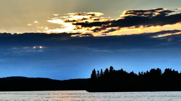 istock The sun that illuminates the dark blue clouds and the river 1053710772