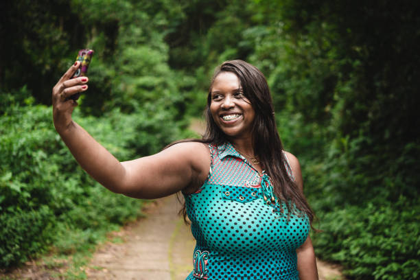 istock Smiling Brazilian woman taking a selfie 1053713824