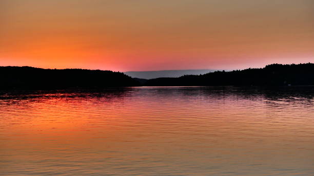 istock Sunset glow with a blue line on the horizon 1053715326