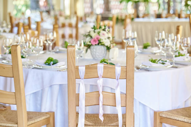 istock Wedding chairs with ribbons near a decorated wedding table 1053715488