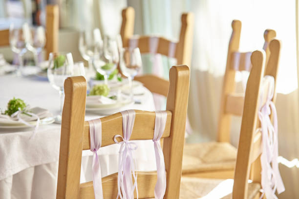istock Wedding chairs with ribbons near a decorated wedding table 1053715522
