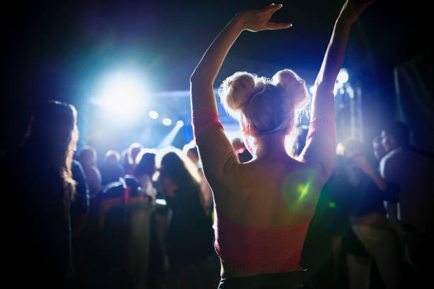 Saturday Night Rear view of a girl dancing at the nightclub. dance floor stock pictures, royalty-free photos & images