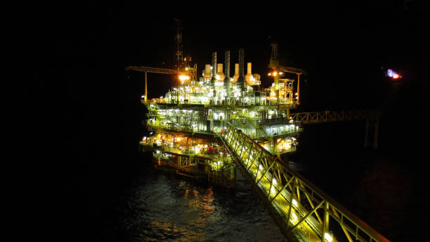 istock Oil and gas industry and hard work at night time. Offshore construction platform for production oil and gas,Production platform and operation process by manual and auto function, oil and rig industry and operation. 1053718136