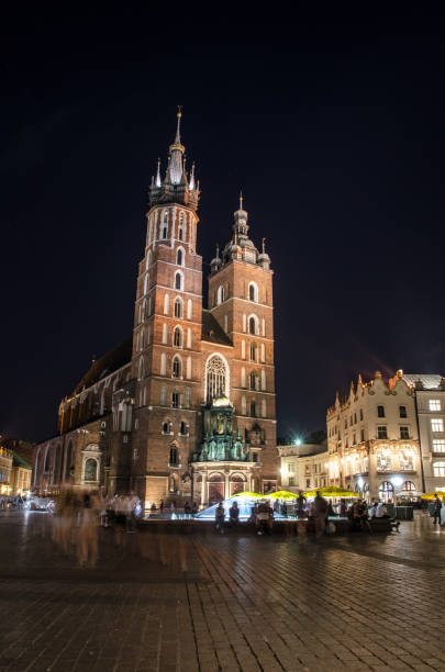 istock Square Market downtown Krakow with St. Mary's Basilica behind during summer day. 1053720414