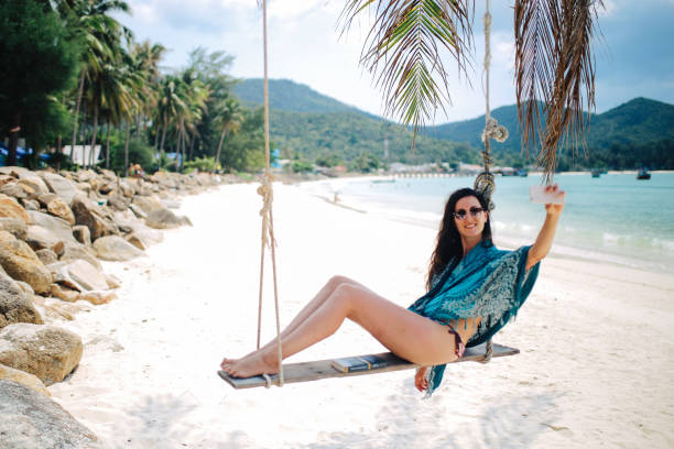 istock Young woman relaxing on the Koh Phangan sandy beach 1053720500
