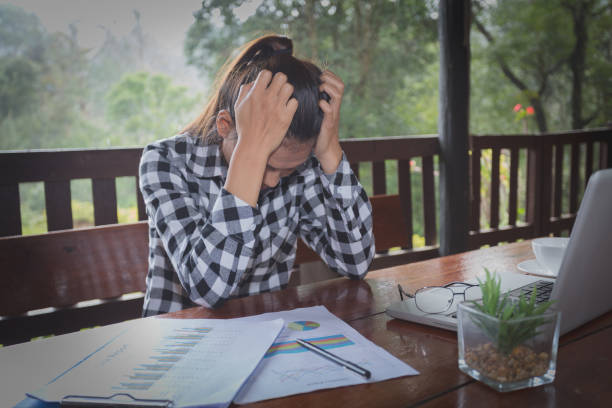 istock Business Woman Having Headache While Working Using Laptop Computer. Stressed And Depressed Girl Touching Her Head, Feeling Pain While Sitting At Wooden Table At Cafe. Work Failure Concept 1053722644