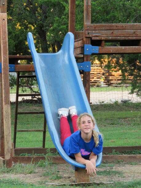 istock girl playing on playground equipment 1053728796