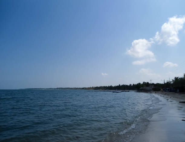 istock White paradisiac beach with blue ocean and calm waves 1053733896