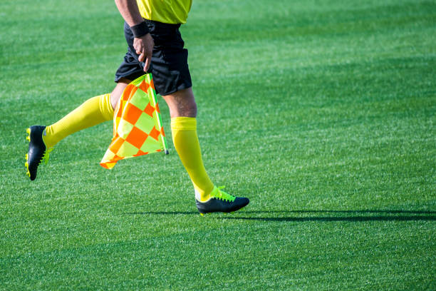 Low Section Of Referee With Flag Running On Soccer Field Photo Taken In Barcelona, Spain referee stock pictures, royalty-free photos & images