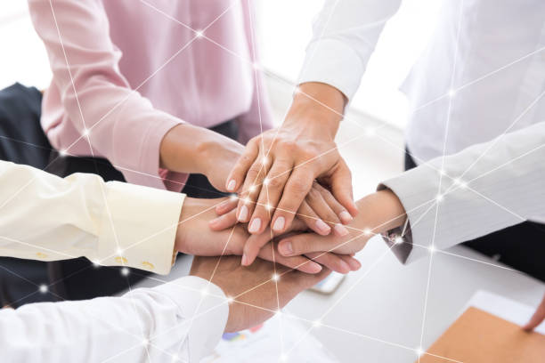 istock Digital Composite Image Of Colleagues Stacking Hands At Office 1053743570
