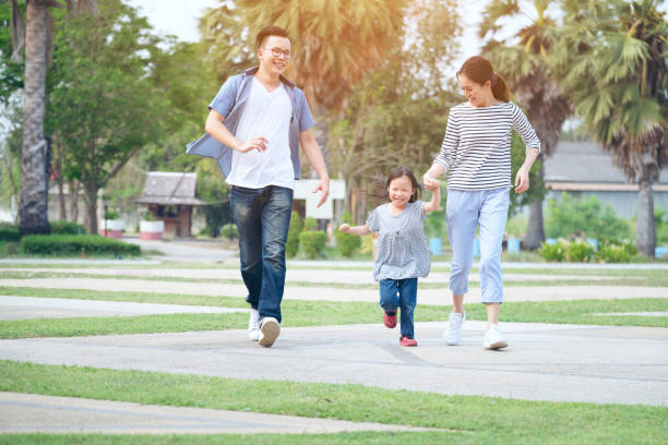 istock Happy Family Walking At Park 1053743788