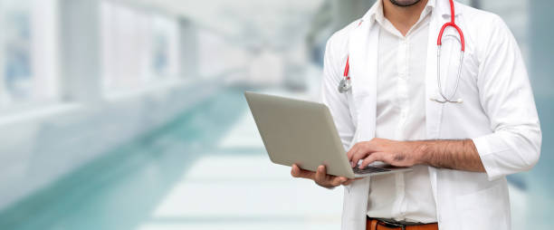 istock Doctor using laptop computer at the hospital. 1053746002