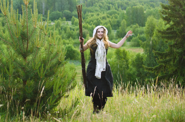 istock young girl witch with broom 1053746444