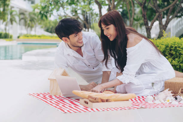 istock Young couple go picnic at the park in summer. 1053748962