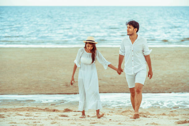 istock Happy young couple walk on the beach on honeymoon. 1053749300