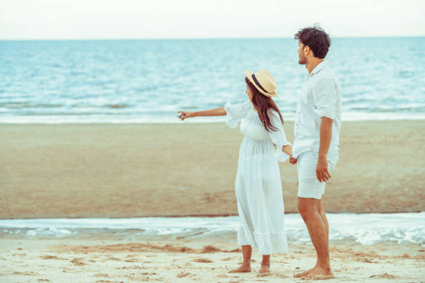 istock Happy young couple walk on the beach on honeymoon. 1053749360