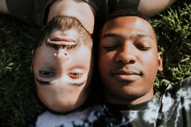 istock Gay couple relaxing in the grass 1053751594