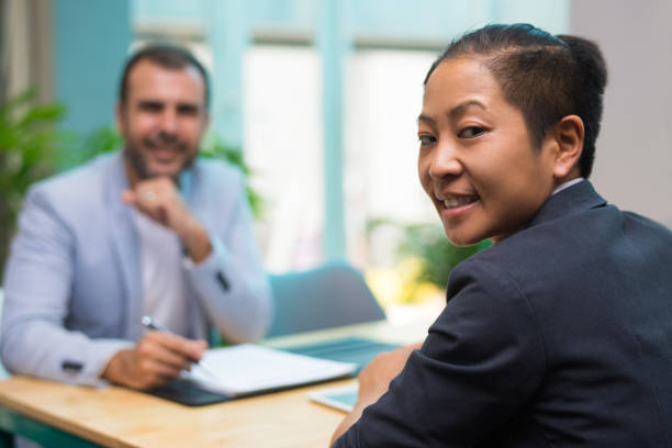 istock Smiling Asian businesswoman in jacket looking at camera 1053761642