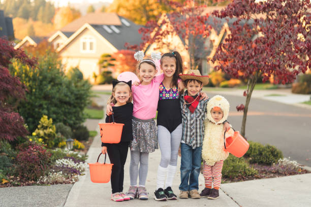 istock Portrait of multiethnic kids trick or treating 1053765472