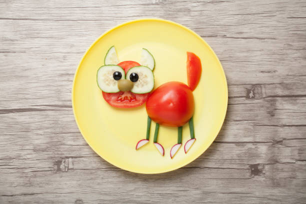 istock Cat made with vegetables on yellow plate and board 1053766646