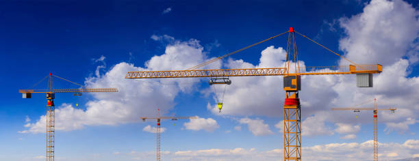 construction cranes on blue cloudy sky background. 3d illustration - tower steel mansion investment imagens e fotografias de stock