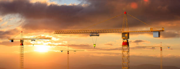 istock Construction cranes on sunset or sunrise background. 3d illustration 1053768422