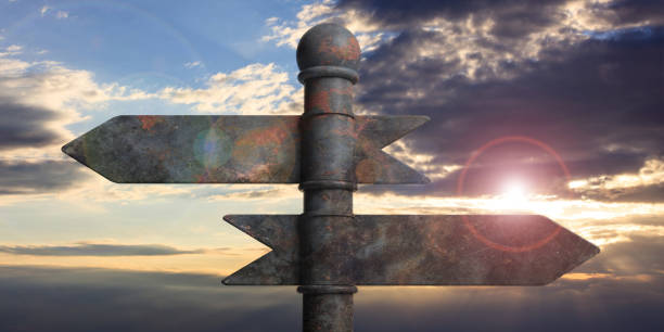 istock Metal pointer signposts on pole, isolated on sunset background. 3d illustration 1053768496