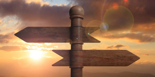 istock Wooden pointer signposts on pole, isolated on sunset background. 3d illustration 1053768502