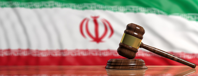 Judge or auction gavel on Iran waving flag background. 3d illustration