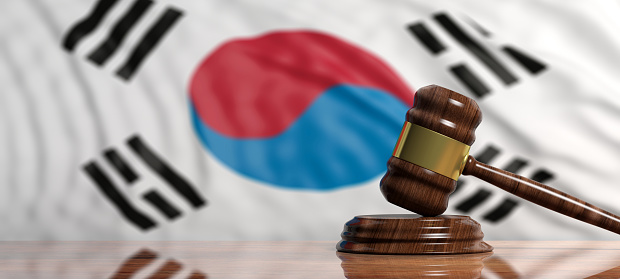 Judge or auction gavel on South Korea waving flag background. 3d illustration