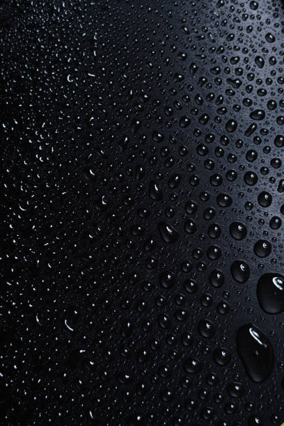 istock Water droplets against dark background 1053768840