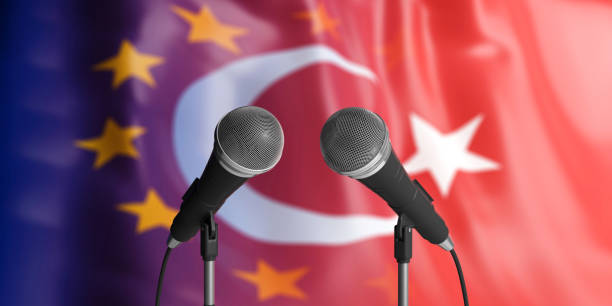 istock EU and Turkey relations. Two cable microphones in front. Flags for background. 3d illustration 1053769010