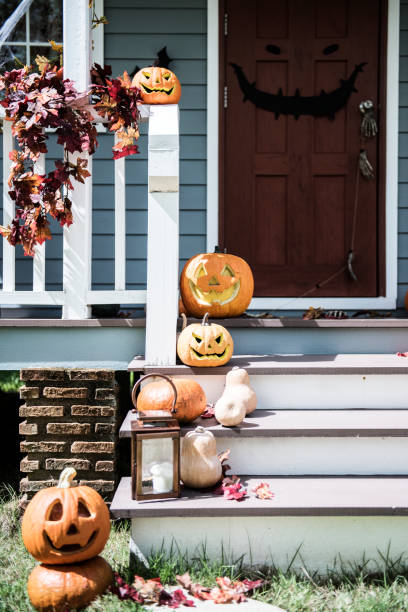 istock Halloween pumpkins and decorations outside a house 1053769282