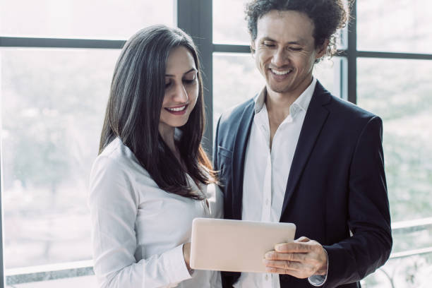 istock Cheerful man and woman analyzing business data 1053773932