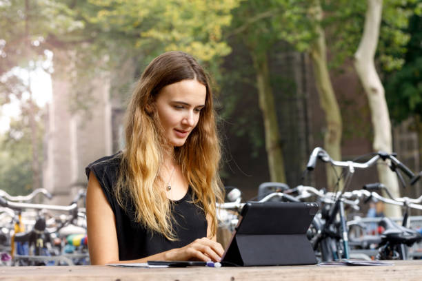 istock Female Student Working On Tablet Outdoors 1053777288