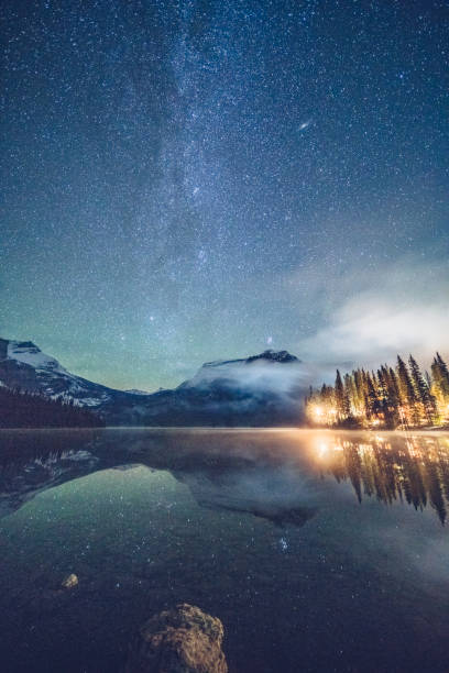 Emerald lake with illuminated cottage under milky way Emerald lake with illuminated cottage under milky way,and Mount Burgess on background,in Yoho national park,British Columbia, Canada. log cabin photos stock pictures, royalty-free photos & images